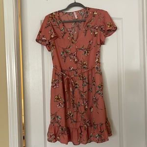 Pink dress with floral pattern. Mid thigh length, button down with waist tie